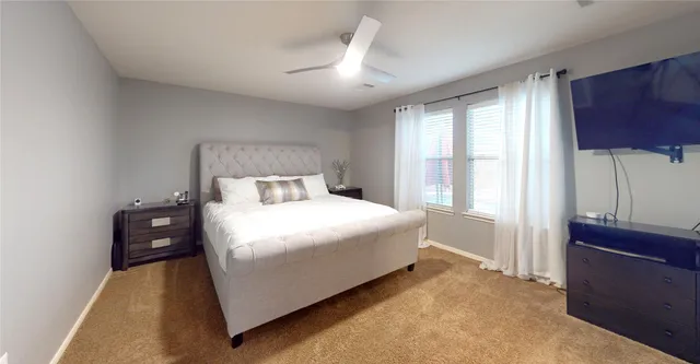 a bedroom with a bed and a potted plant