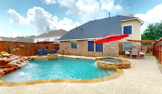a swimming pool with patio outdoor seating and yard