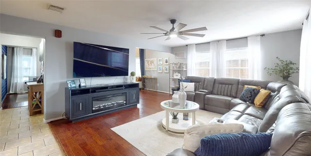 a living room with furniture a fireplace and a flat screen tv