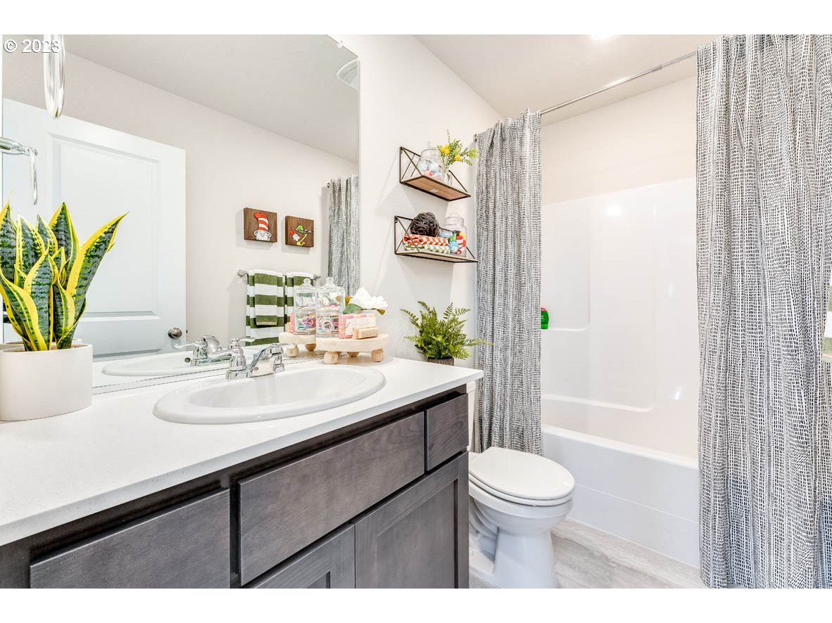1002 Northwest 175th Way Ridgefield, WA 98642 - Photo 17 of 26 a bathroom with a sink a toilet and shower