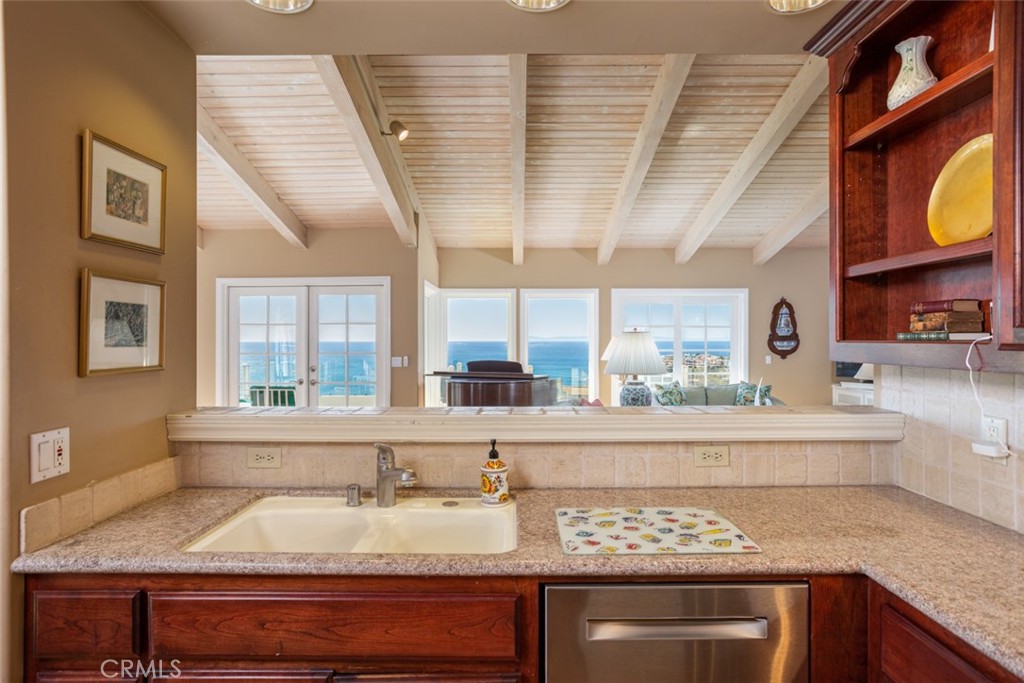 521 Emerald Bay Laguna Beach, CA 92651 - Photo 22 of 42 a view of a kitchen with granite countertop stainless steel appliances sink stove and cabinets