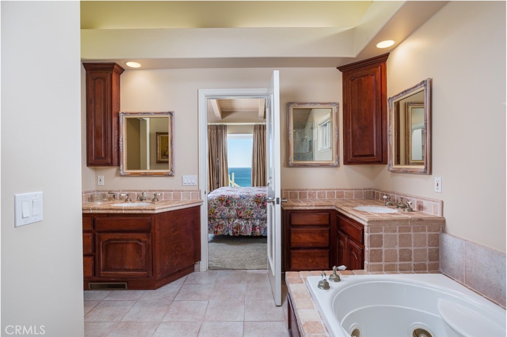 521 Emerald Bay Laguna Beach, CA 92651 - Photo 28 of 42 a bathroom with a tub sink and mirror
