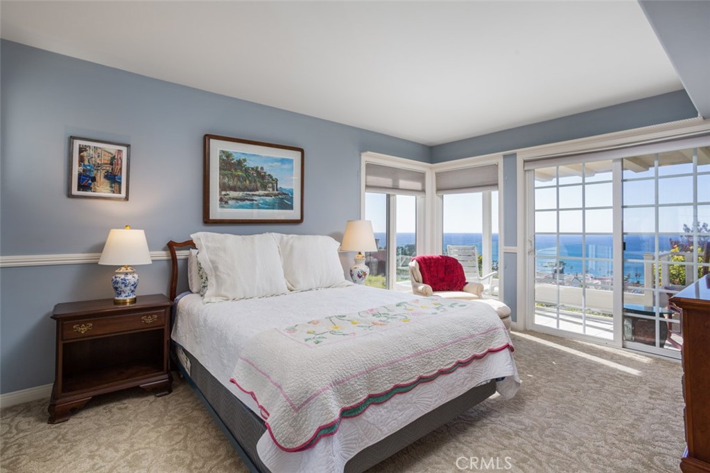 521 Emerald Bay Laguna Beach, CA 92651 - Photo 33 of 42 a bedroom with a bed and wooden floor