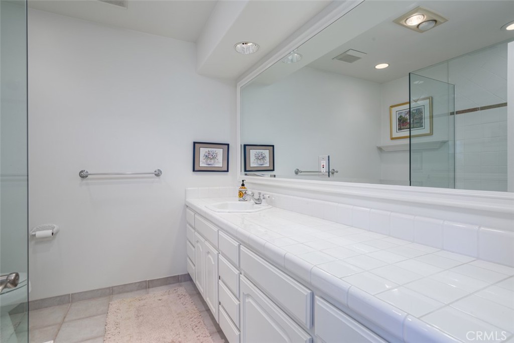521 Emerald Bay Laguna Beach, CA 92651 - Photo 34 of 42 a bathroom with a sink and a mirror