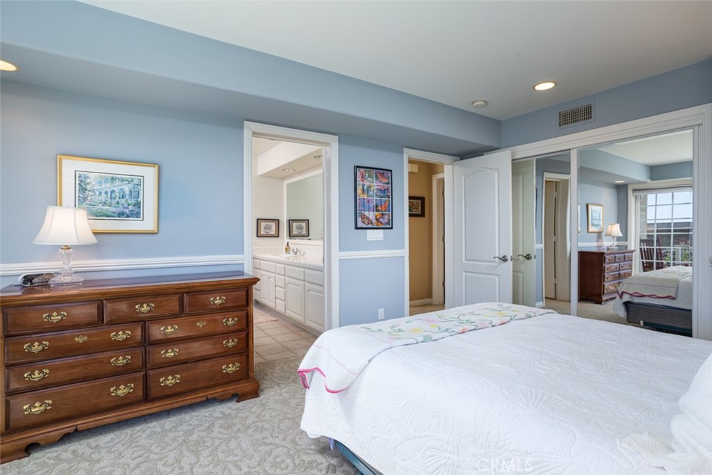 521 Emerald Bay Laguna Beach, CA 92651 - Photo 35 of 42 a spacious bedroom with a bed and a dresser