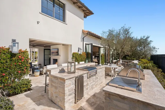a view of a house with backyard porch and sitting area