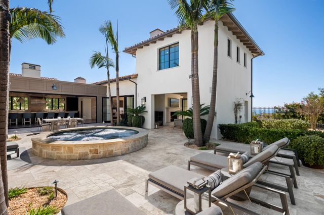 a view of a patio with table and chairs potted plants and palm tree