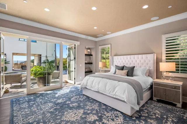 a bedroom with a bed and ceiling fan