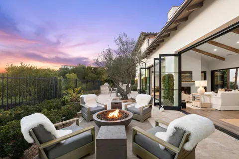 a front view of a house with garden and patio