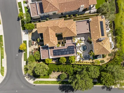 an aerial view of a house with a swimming pool