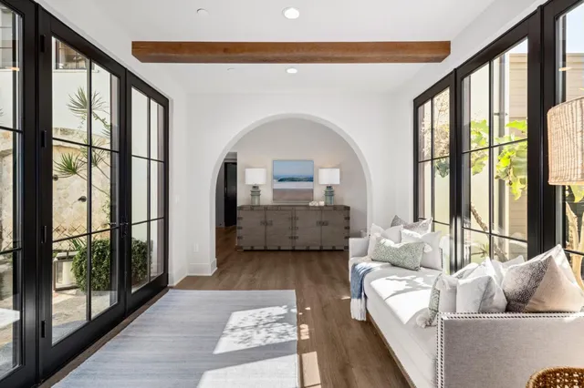 a living room with furniture and a floor to ceiling window