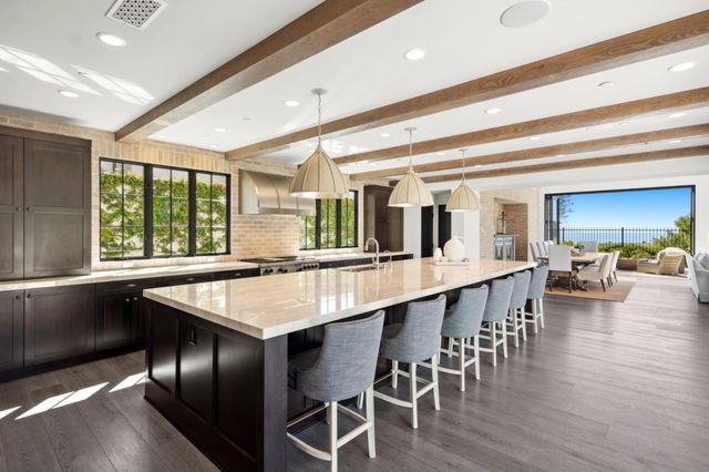 a large kitchen with a table and chairs