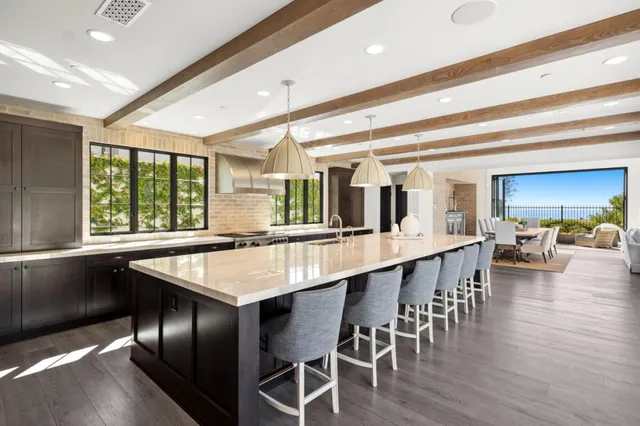 a large kitchen with a table and chairs