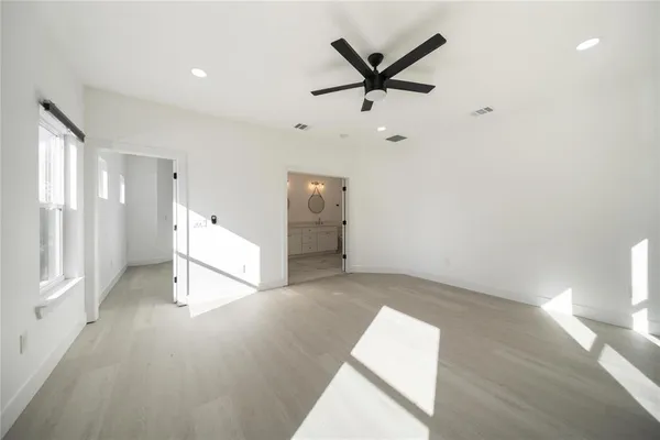 a view of a livingroom with a ceiling fan and window