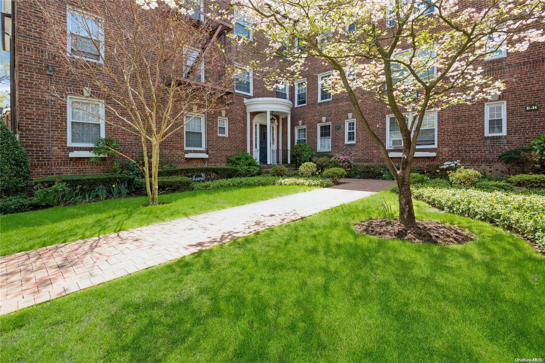 8 Welwyn Road, Unit 3G Great Neck, NY 11021 - Photo 1 of 1 a front view of a house with yard and green space