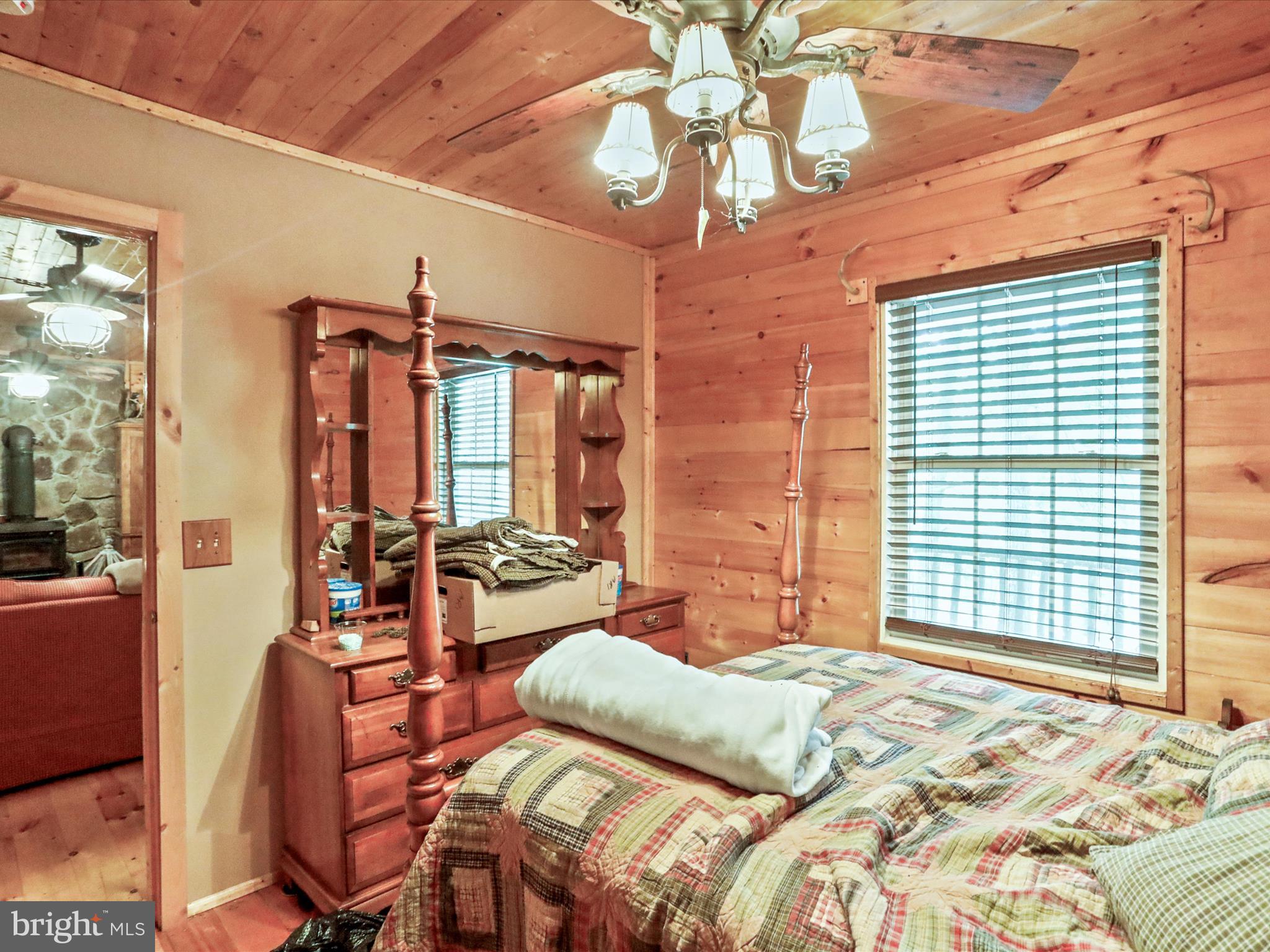 2180 Old Smith Farm Road Springfield, WV 26763 - Photo 11 of 24 a bedroom with furniture and a chandelier