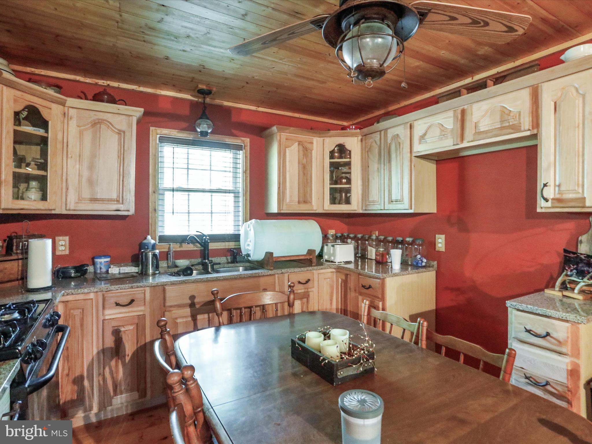 2180 Old Smith Farm Road Springfield, WV 26763 - Photo 4 of 24 a kitchen with stainless steel appliances granite countertop a stove a sink dishwasher and cabinets with wooden floor