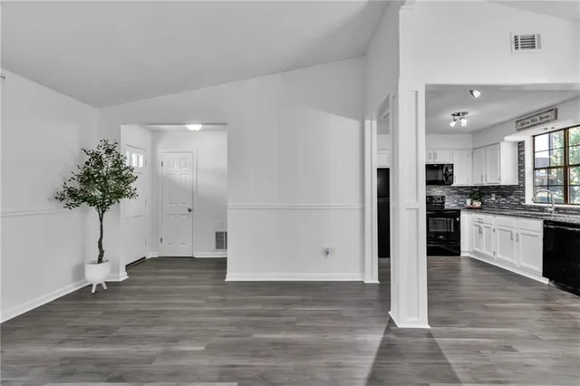 a kitchen with granite countertop a refrigerator and a sink