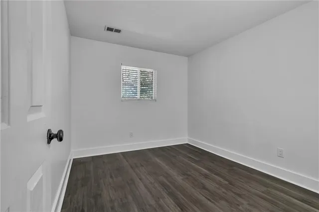a view of a room with wooden floor and window