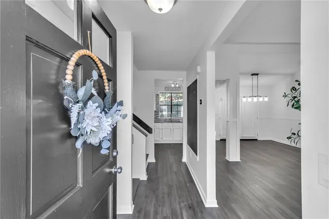 a view of a hallway with wooden floor and staircase