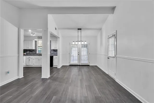 a view of a kitchen with wooden floor and a window