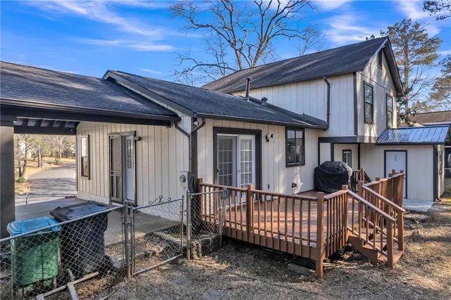 a view of a house with wooden fence and a porch