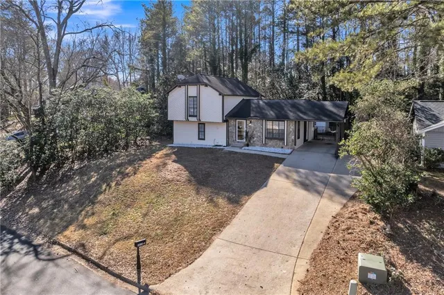 a front view of a house with a yard and mountain view