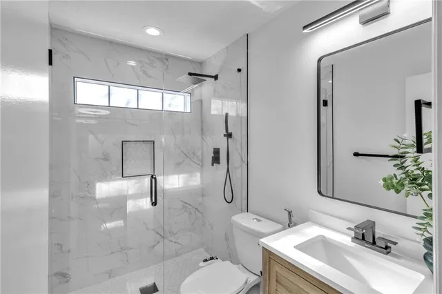 a bathroom with a sink toilet and shower