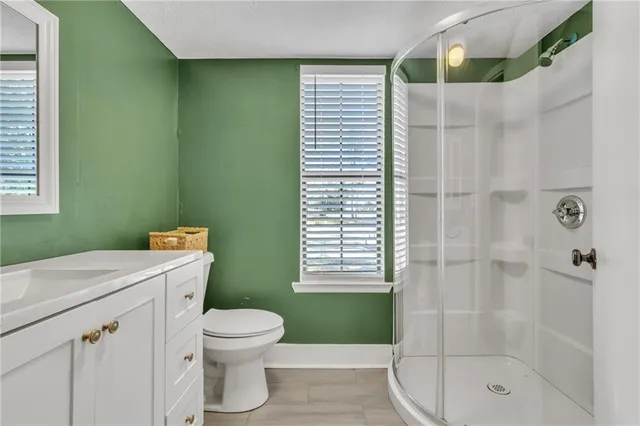 a bathroom with a shower a toilet and a sink