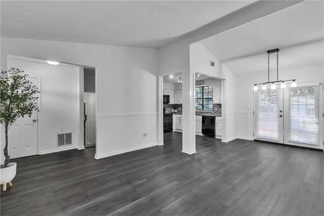 a view of a kitchen with wooden floor and a window