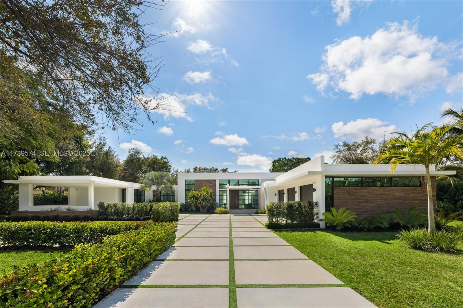 a front view of a house with a garden