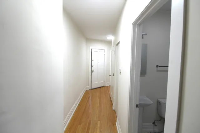 a view of room with window and wooden floor