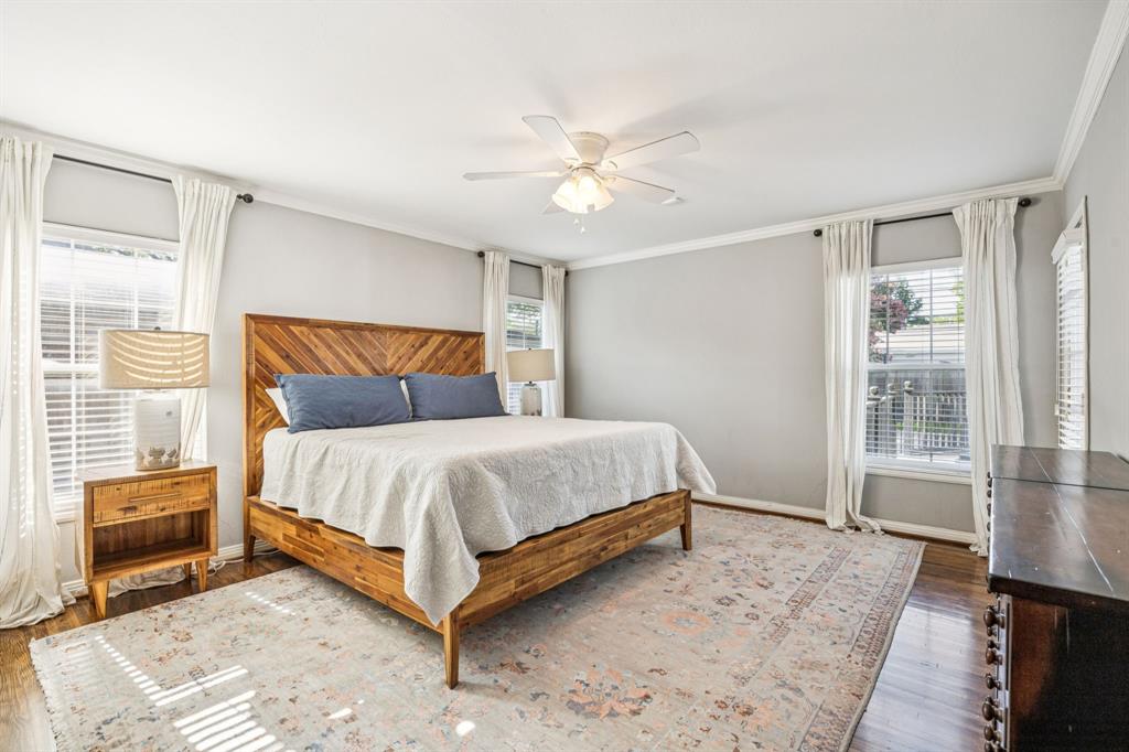 6342 Anita Street Dallas, TX 75214 - Photo 17 of 26 a bedroom with a bed lamp and a large window