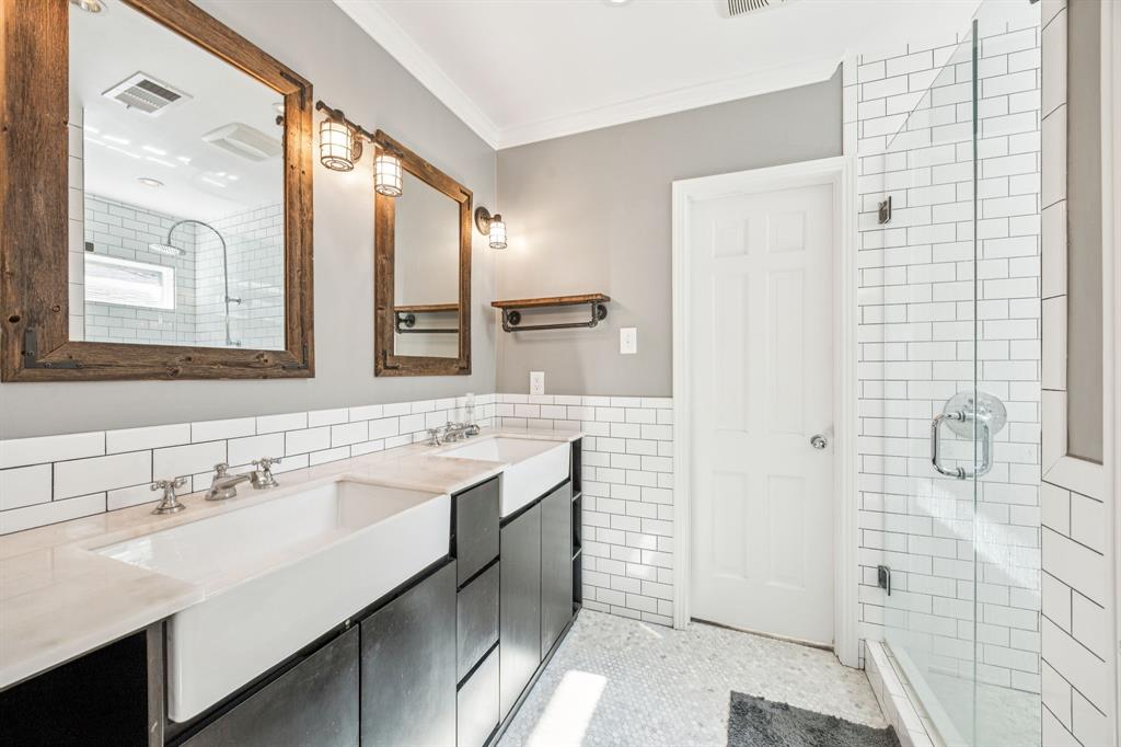 6342 Anita Street Dallas, TX 75214 - Photo 20 of 26 a bathroom with a sink a mirror and a shower