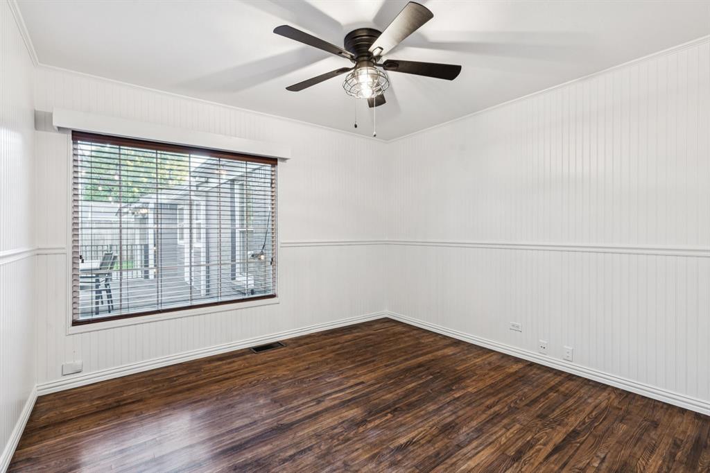 6342 Anita Street Dallas, TX 75214 - Photo 21 of 26 a view of a big room with wooden floor and a chandelier fan
