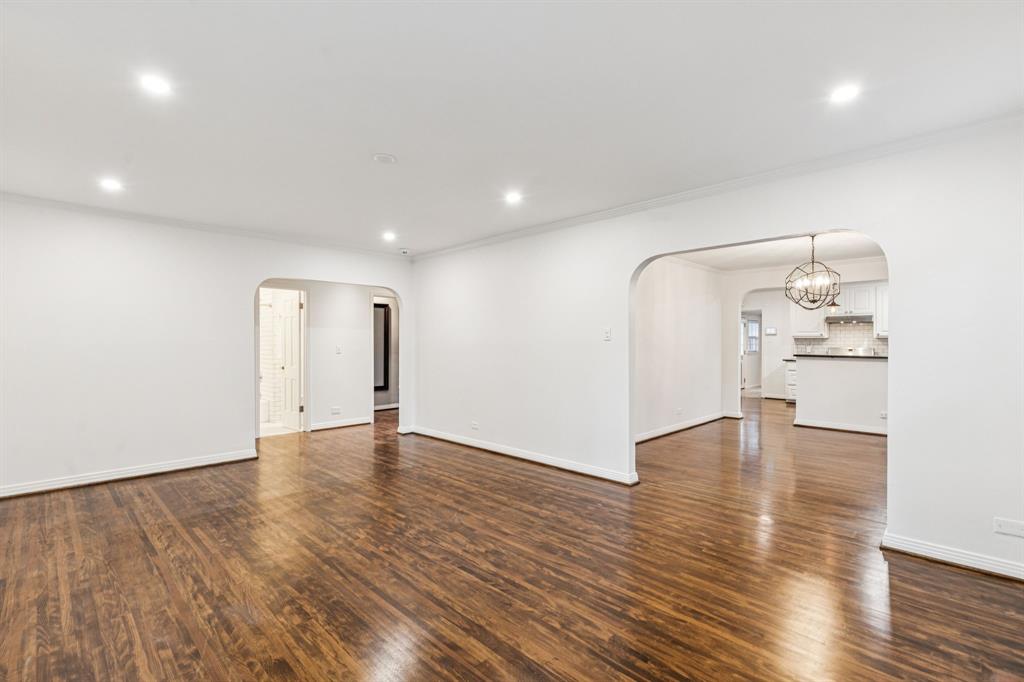 6342 Anita Street Dallas, TX 75214 - Photo 8 of 26 a view of an empty room with wooden floor and a window