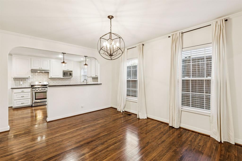 6342 Anita Street Dallas, TX 75214 - Photo 10 of 26 a view of a kitchen with wooden floor and windows