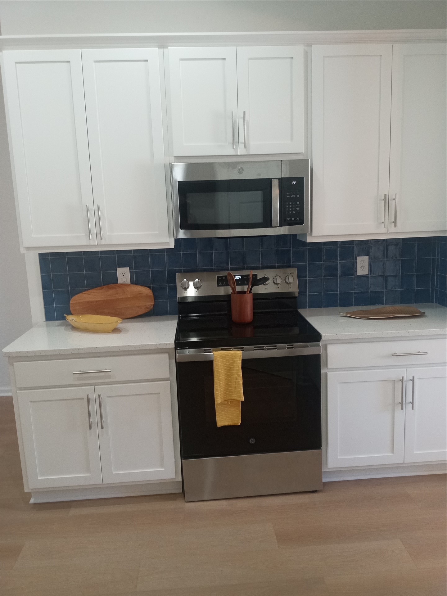 96052 Pirates Bluff Road Yulee, FL 32097 - Photo 11 of 22 a kitchen with white cabinets and black appliances