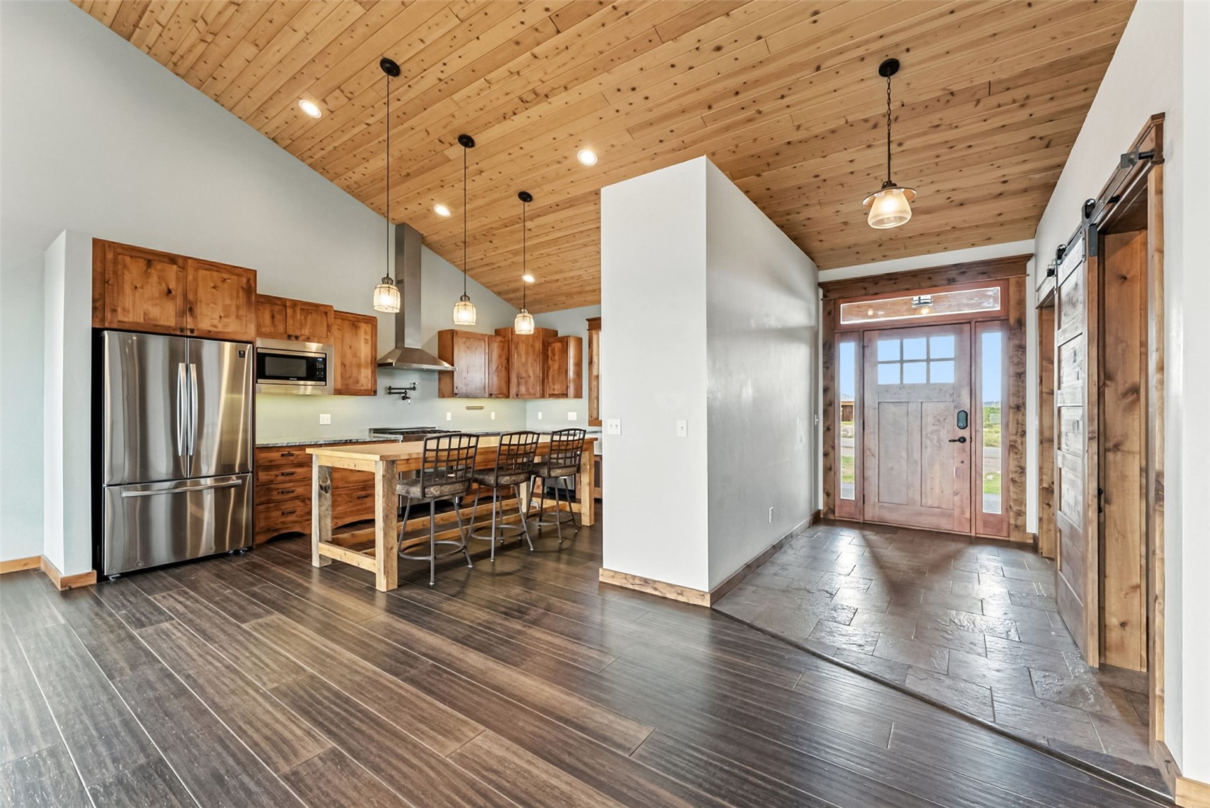 701 Clark Street Fairplay, CO 80440 - Photo 12 of 50 Eat-in kitchen with custom cabinetry, butcher block island, walk-in pantry, granite counters, pot filler, built-in coffee/baking station, engineered bamboo flooring, and in-floor radiant heat.Option 2 (slightly warmer, still MLS-safe)Chefs eat-in kitchen featuring custom cabinetry, granite counters, butcher block island, walk-in pantry, pot filler, built-in coffee or baking station, engineered bamboo floors, and in-floor radiant heat.