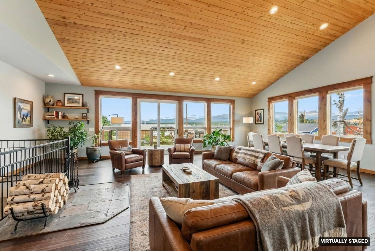 701 Clark Street Fairplay, CO 80440 - Photo 4 of 50 Virtually staged great room featuring open living and dining areas, a designated area for a freestanding wood stove, and an inviting reading nook.