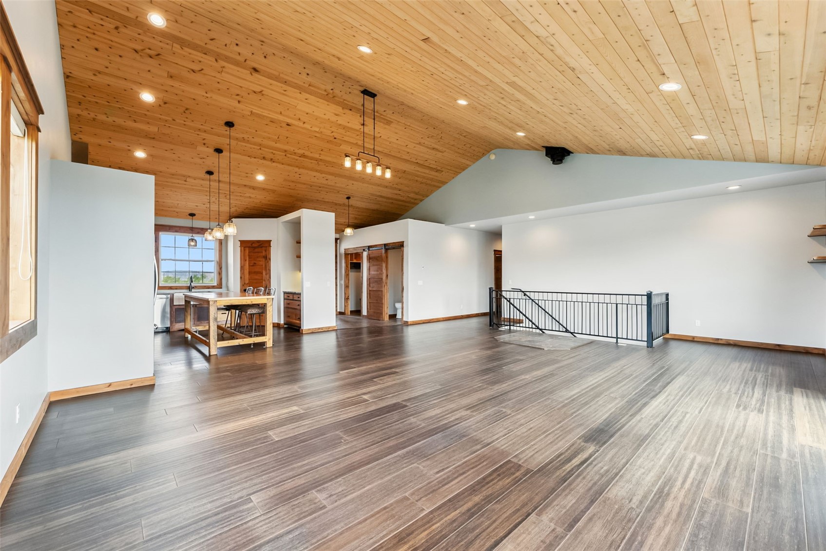 701 Clark Street Fairplay, CO 80440 - Photo 7 of 50 Great room with open living and dining areas, engineered bamboo floors, radiant heat, designated space for a freestanding wood stove, an inviting reading nook, and access to the deck