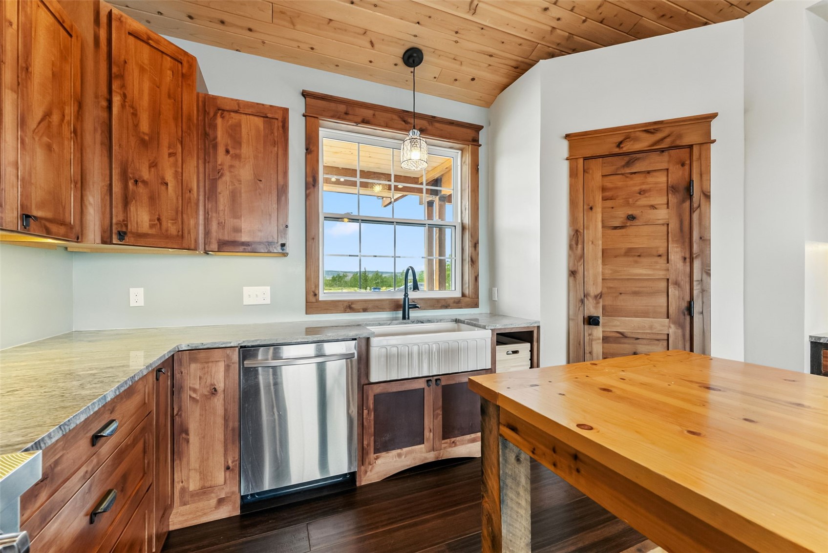 701 Clark Street Fairplay, CO 80440 - Photo 10 of 50 Eat-in kitchen with custom cabinetry, butcher block island, walk-in pantry, granite counters, pot filler, built-in coffee/baking station, engineered bamboo flooring, and in-floor radiant heat.Option 2 (slightly warmer, still MLS-safe)Chefs eat-in kitchen featuring custom cabinetry, granite counters, butcher block island, walk-in pantry, pot filler, built-in coffee or baking station, engineered bamboo floors, and in-floor radiant heat.