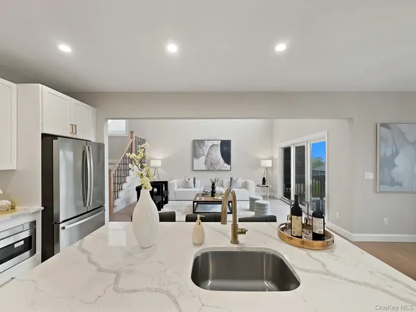 a kitchen with a sink refrigerator and cabinets
