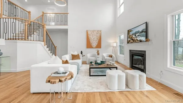 a living room with furniture fireplace and rug