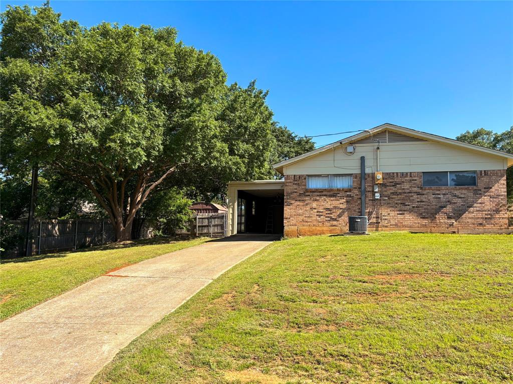 1829 South Center Street Denison, TX 75021 - Photo 5 of 29 a front view of a house with a yard