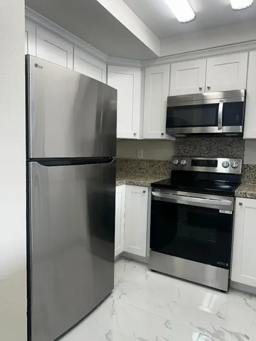 a white refrigerator freezer and a stove top oven