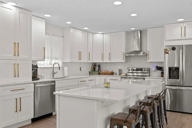 a large kitchen with lots of table and chairs