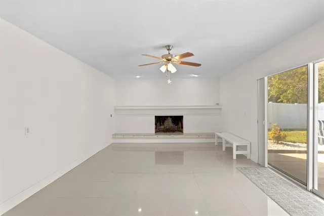 wooden floor in an empty room with a fireplace