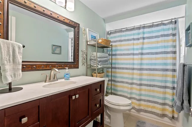a view of a livingroom with workspace and a bookshelf