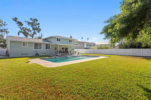 a view of a patio with a dining table and chairs with wooden floor